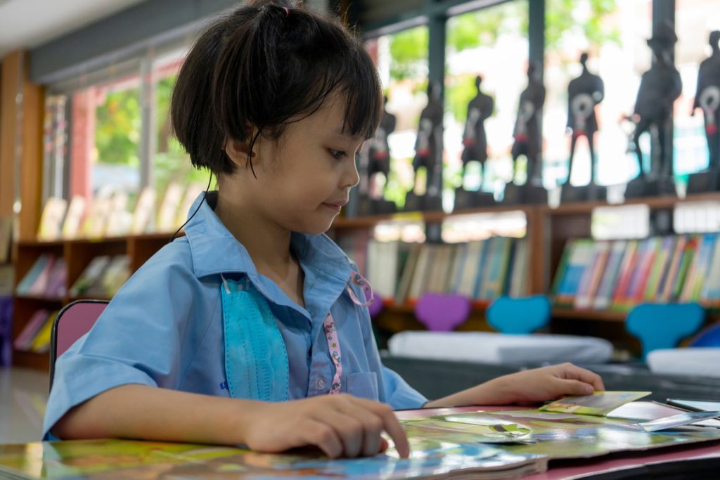 girl reading at the library