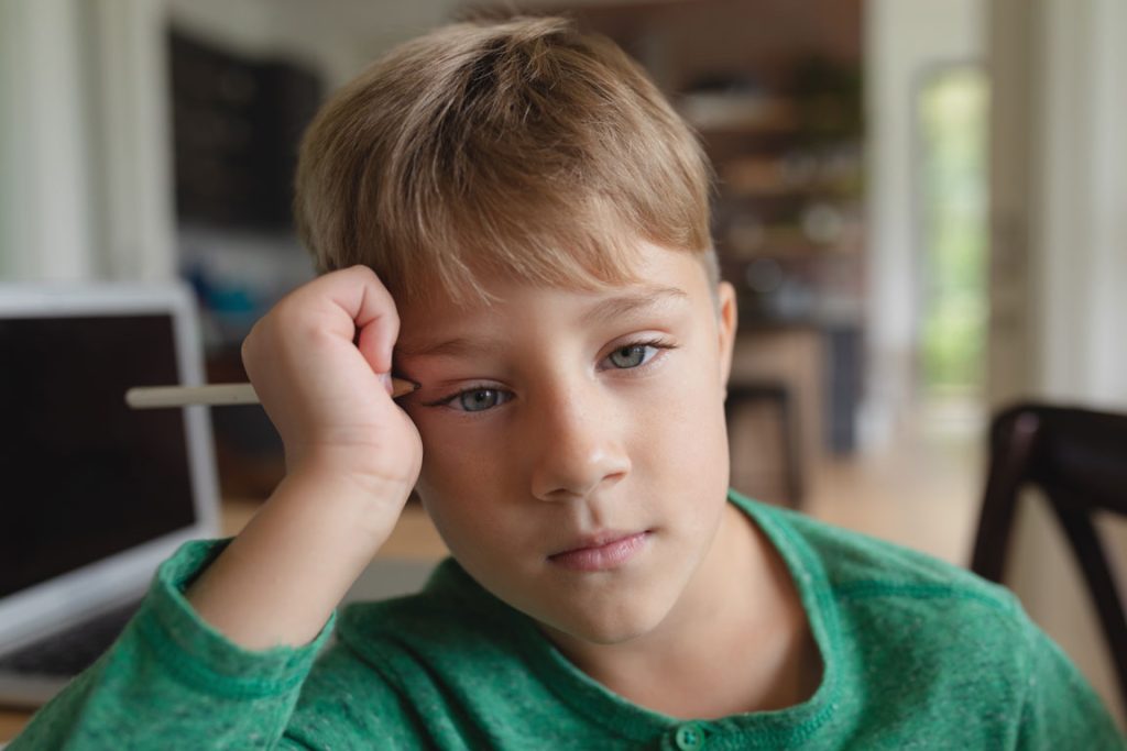 confused boy in school class